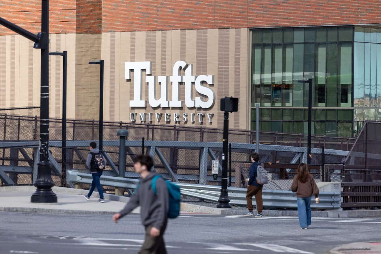 People walk on College Avenue near Tufts University in Medford, Mass., on March 27, 2025. Photo by Scott Eisen/Getty Images.