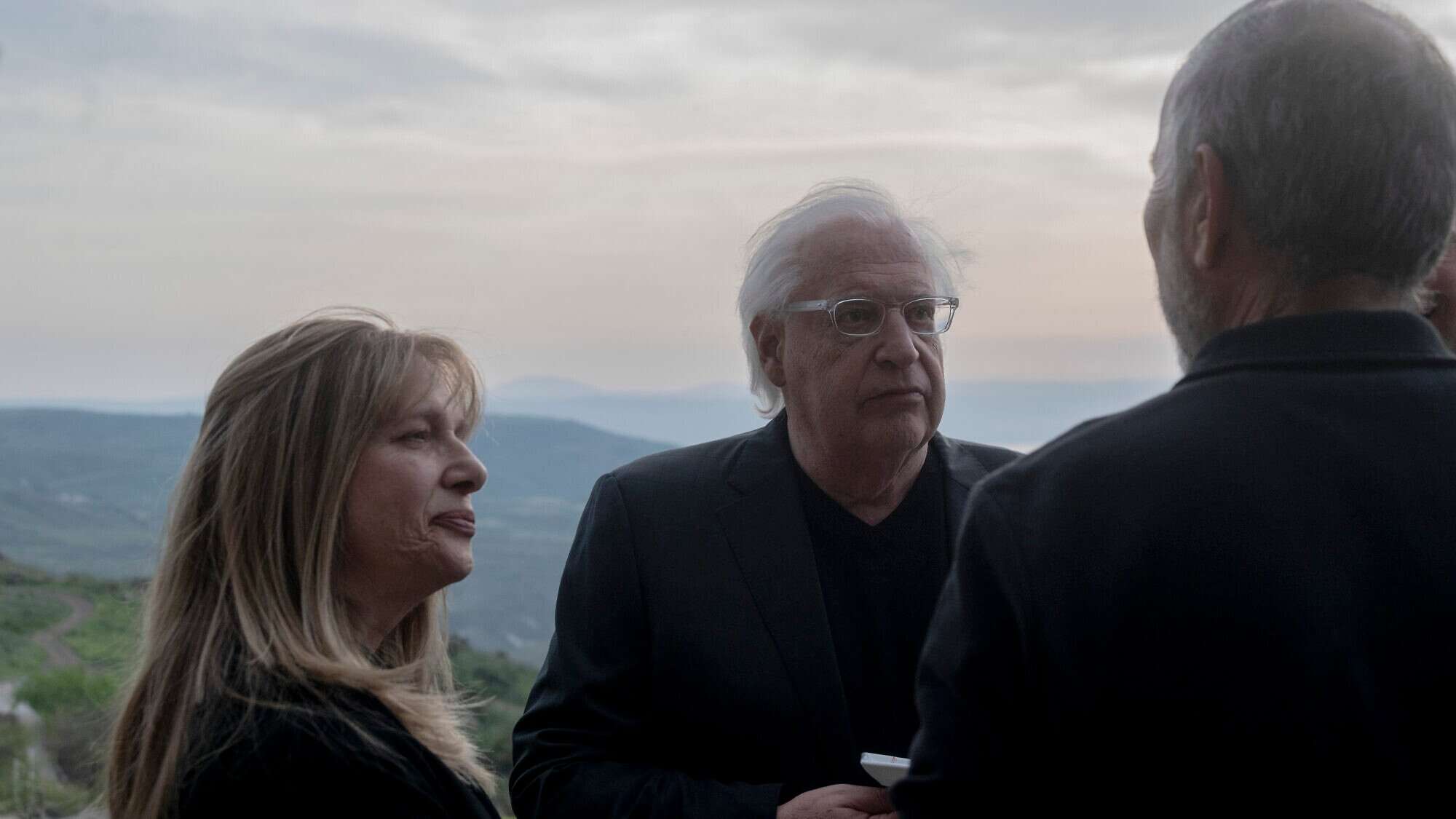 David and Tammy Friedman, facing camera, speak to an attendant of a ceremony held at Ein Kshatot, Israel on March 25, 2025. Photo by Canaan Lidor.