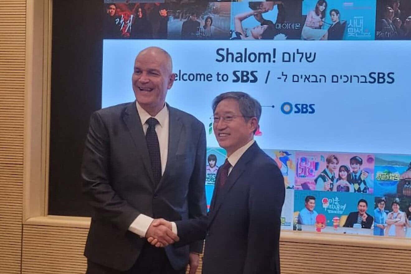 Rafi Harpaz, left, meets an interlocutor at an Israeli embassy event in Seoul, South Korea on March 26, 2025. Photo credit: Courtesy of the Israeli embassy in Seoul.