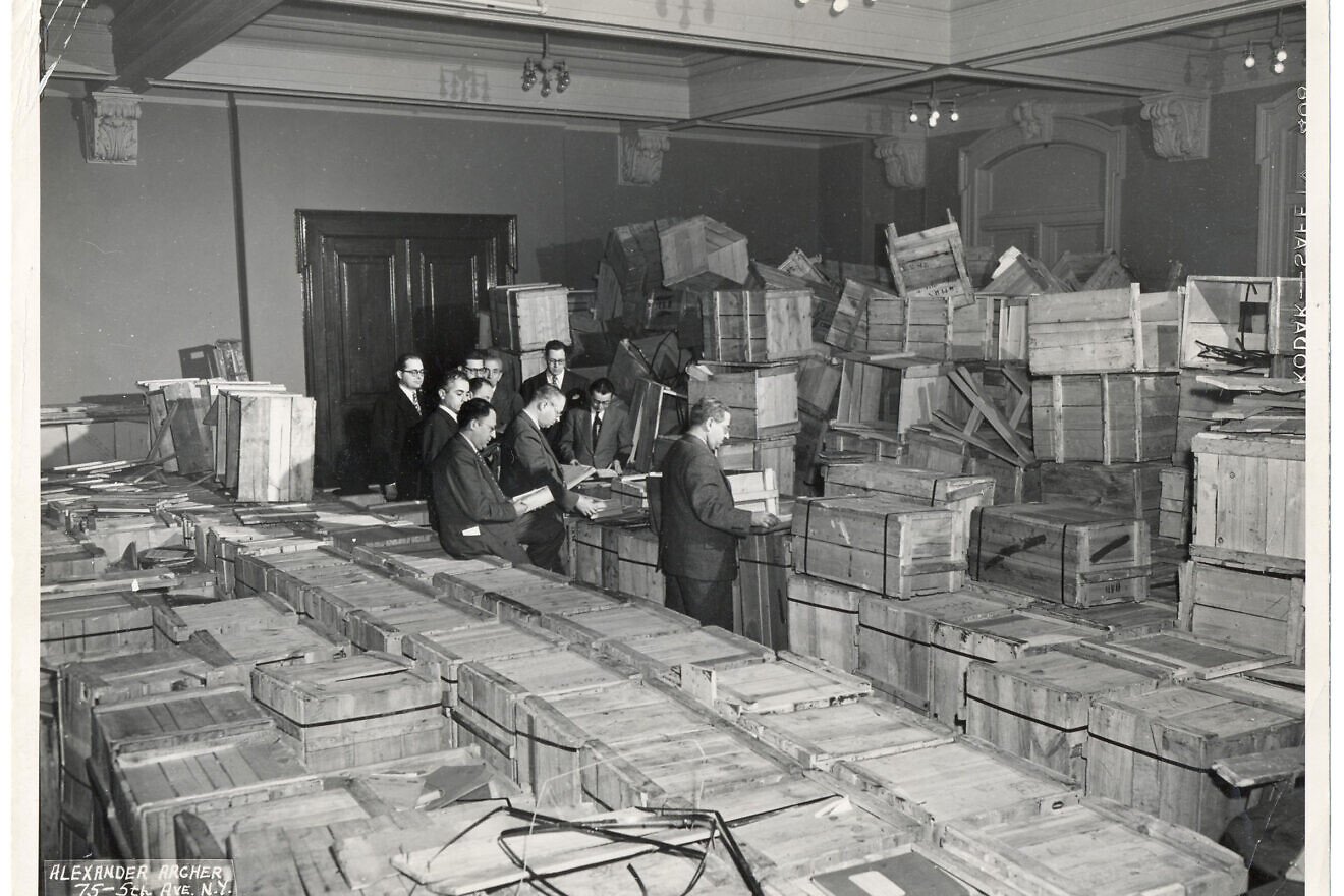 Leaders of the New York-based YIVO Institute for Jewish Research opening crates of salvaged materials. Credit: Courtesy of YIVO.