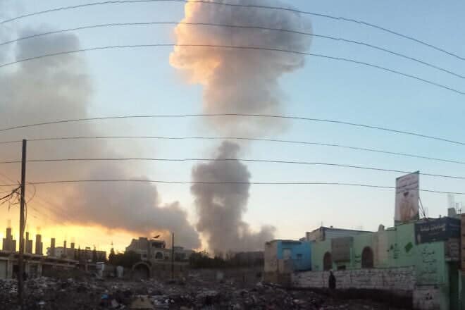 Smoke billows from the site of an air strike in Saana, Yemen. Photo by Ibrahem Qasima/Wikimedia Commons