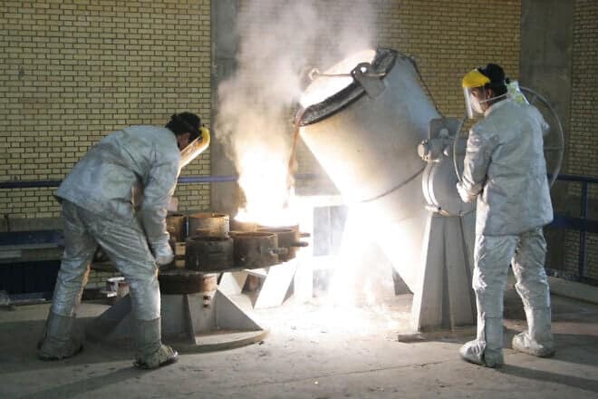 Technicians work inside a uranium conversion facility producing unit just outside Isfahan, Iran, on March 30, 2005. Photo by Getty Images.