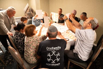Bereaved families comfort one another at OneFamily's pre-Memorial Day retreat at the Kinneret. Photo by Meir Pavlovsky. 