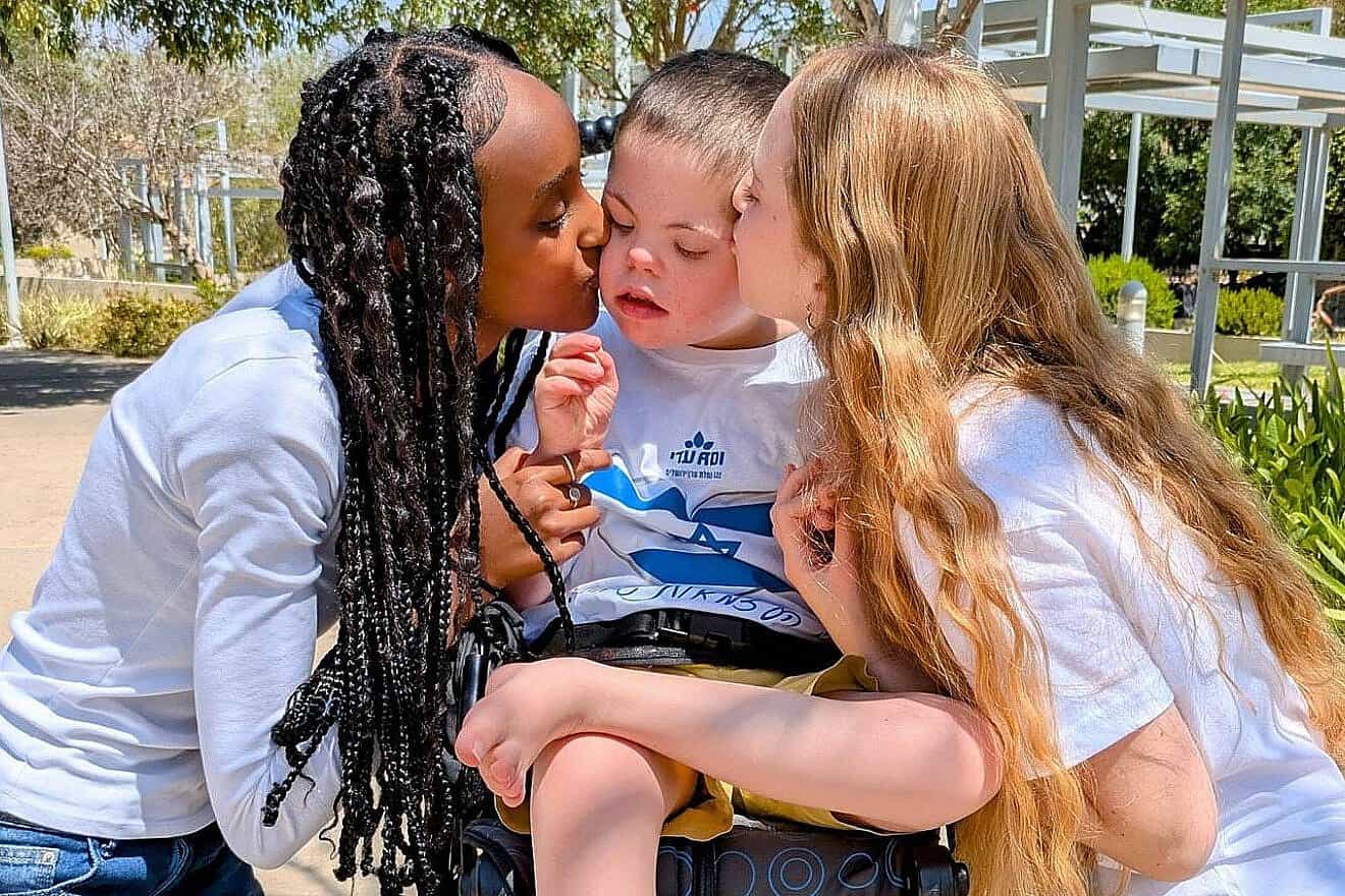 National Service volunteers at the ADI Negev-Nahalat Eran rehabilitation village dote on a special-education student with severe disabilities, 2025. Credit: Courtesy of ADI.