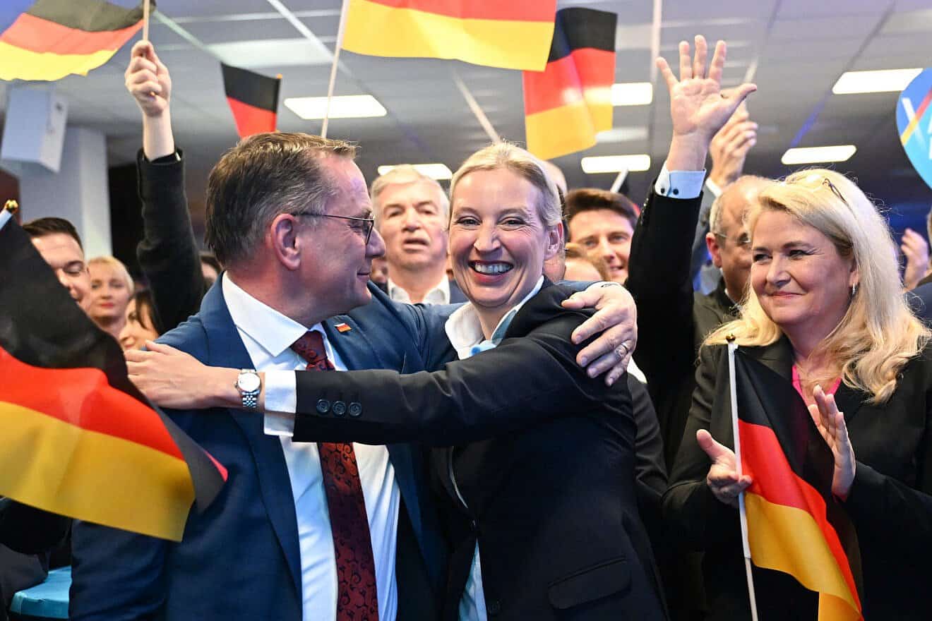 Alice Weidel (center), federal chairwoman and candidate for chancellor of the AfD, celebrates with party federal chairperson Tino Chrupalla (left) as they react to the exit poll results at AfD headquarters in Berlin, on Feb. 23, 2025. Photo by Soren Stache-Pool/Getty Images.