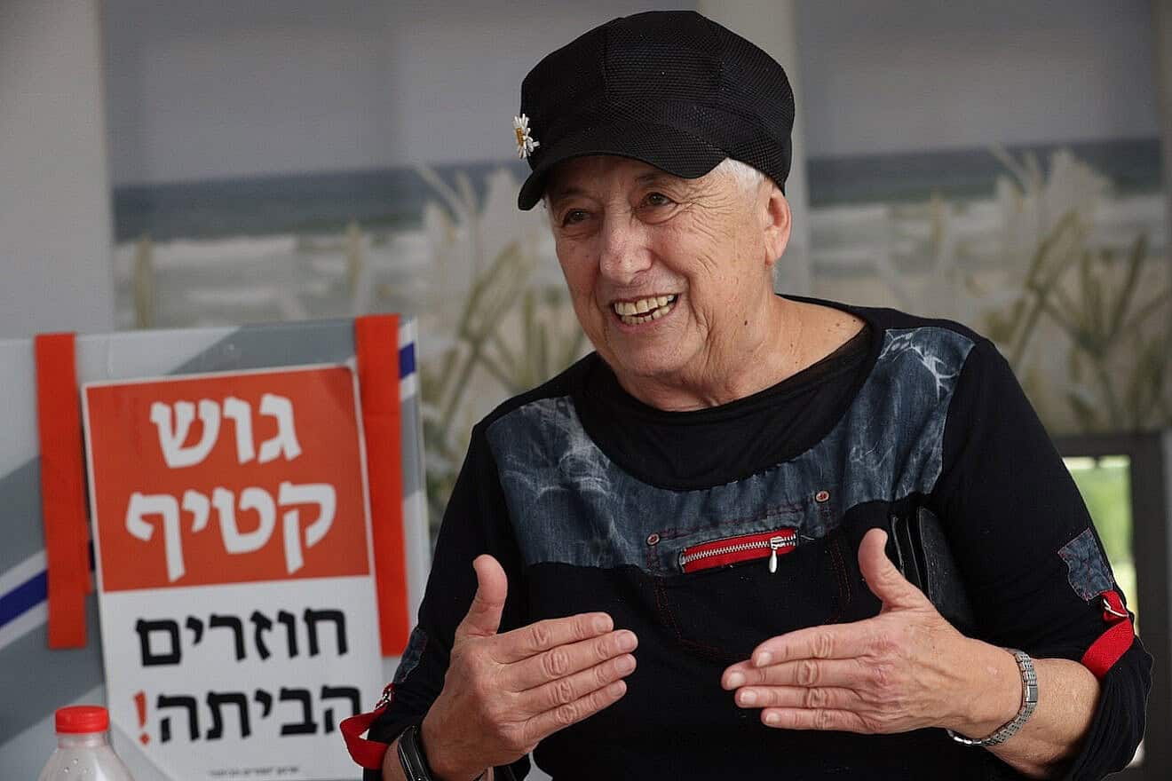 Anita Tucker surrounded by memories of Gush Katif, including an orange sign announcing a return “home.” Photo by Yossi Zamir.