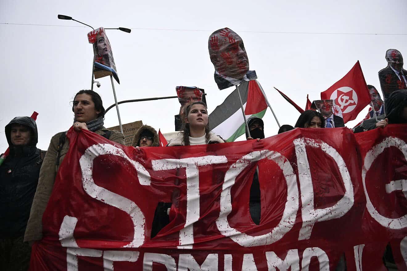 Anti-Israel protesters hold a red banner with the word “Stop” and effigies of Israeli Prime Minister Benjamin Netanyahu, Italian Prime Minister Giorgia Meloni and other leaders during a demonstration in Milan, Italy, on Feb. 24, 2024. Photo by Stefano Guidi/Getty Images.