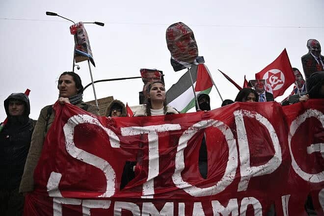Anti-Israel protesters hold a red banner with the word “Stop” and effigies of Israeli Prime Minister Benjamin Netanyahu, Italian Prime Minister Giorgia Meloni and other leaders during a demonstration in Milan, Italy, on Feb. 24, 2024. Photo by Stefano Guidi/Getty Images.