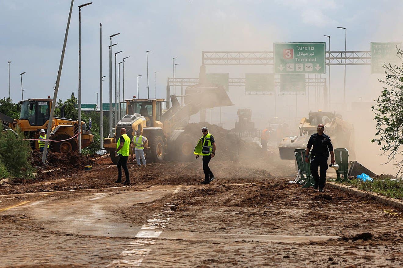 Emergency services clear a road outside Israel's Ben-Gurion International Airport after a Yemeni missile struck near the facility, on May 4, 2025. Photo by Jack Guez/AFP via Getty Images.