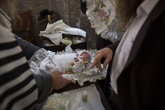 Haredi Jews perform a “brit milah” by a mohel (“circumciser”) in the neighborhood of Mea She’arim in Jerusalem, Nov.  9, 2014. Photo by Yonatan Sindel/Flash90.