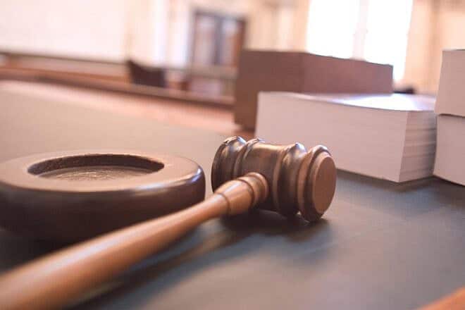 Gavel on a courtroom table. Credit: Joe Gratz via Wikimedia Commons.