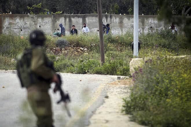 Palestinian terrorists hurl rocks at Israeli security personnel in the Samaria city of Ramallah, April 13, 2015. Photo by STR/Flash90.