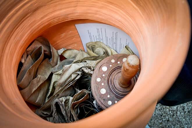 Remnants of Torah scrolls found years after being hidden were buried in Warsaw on April 19, 2017. Photo by Yossi Zeliger/Flash90.