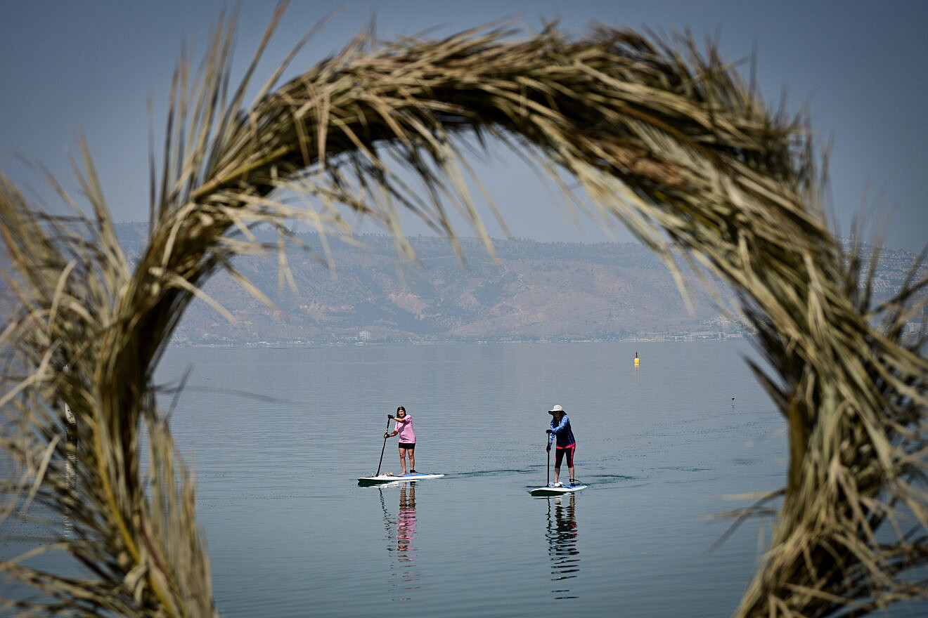 People stand up paddle boarding in the Kinneret in the northern Israeli town of Tiberias, May 23, 2024. Credit: Michael Giladi/Flash90.