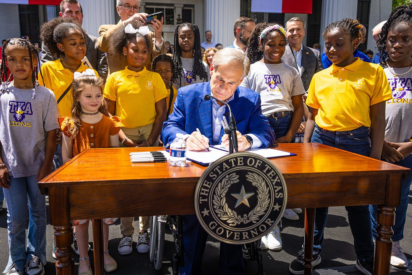 Texas Gov. Greg Abbott signs a statewide school choice bill into law at the governor's mansion in Austin on May 3, 2025. Credit: Texas governor's office.