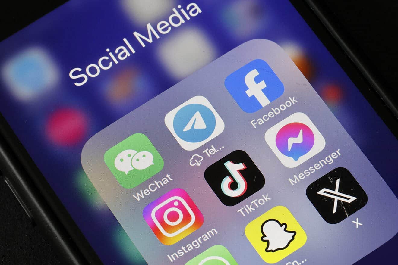 In this photo illustration, WeChat, Telegram, Facebook, Instagram,TikTok Messenger, Snapchat and X applications logos are displayed on the screen of an iPhone on April 24, 2024 in Paris, France. Photo illustration by Chesnot/Getty Images.