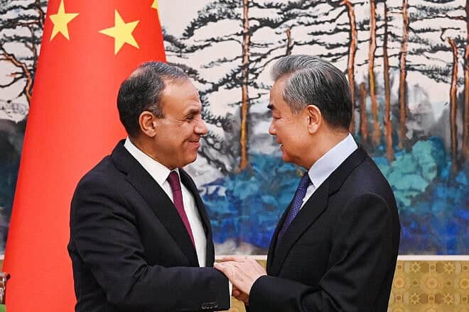 China's Foreign Minister Wang Yi (right) and Egypt's Foreign Minister Badr Abdelatty shake hands after a joint briefing at the Diaoyutai State Guesthouse in Beijing, on Dec. 13, 2024. Photo by GREG BAKER/POOL/AFP via Getty Images.