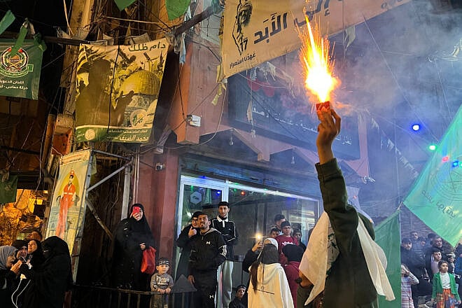 Palestinians celebrate in the Ein el-Hilweh camp, on the outskirts of the Lebanese port of Sidon, following the announcement of a ceasefire in Gaza, on Jan. 15, 2025. Photo by Mahmoud Zayyat/AFP via Getty Images.