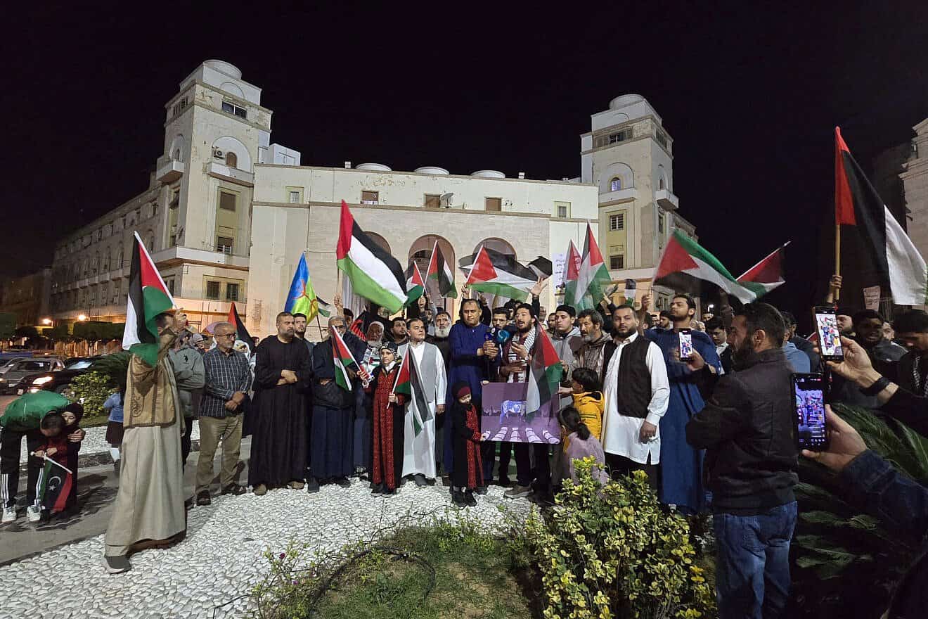 People hold PLO flags as they rally in support of Palestinians at Algeria Square in Tripoli, Libya, on March 18, 2025. Photo by Mahmud Turkia/AFP via Getty Images.