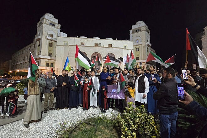 People hold PLO flags as they rally in support of Palestinians at Algeria Square in Tripoli, Libya, on March 18, 2025. Photo by Mahmud Turkia/AFP via Getty Images.