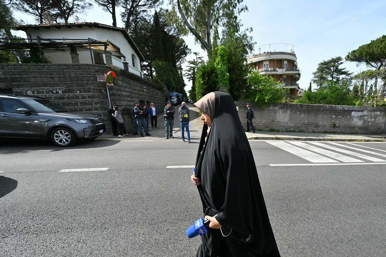 An Iranian state TV channel staffer walks near the Omani embassy in Rome where a second round of nuclear talks are being held between Iran and the United States on April 19, 2025. Photo by Andreas Solaro/AFP via Getty Images.
