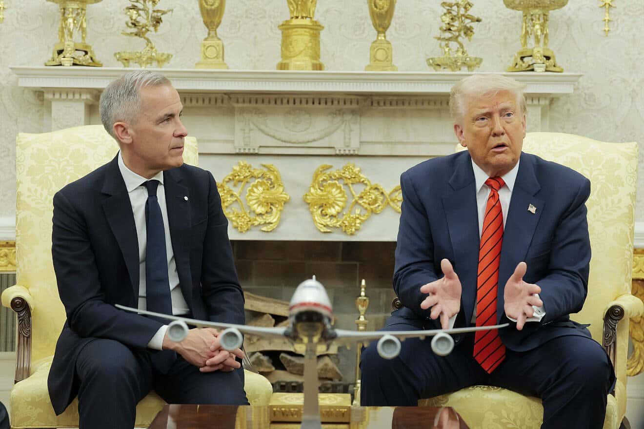 Canadian Prime Minister Mark Carney listens as U.S. President Donald Trump speaks to reporters in the Oval Office at the White House in Washington, D.C., on May 6, 2025. Photo by Anna Moneymaker/Getty Images.