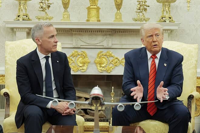 Canadian Prime Minister Mark Carney listens as U.S. President Donald Trump speaks to reporters in the Oval Office at the White House in Washington, D.C., on May 6, 2025. Photo by Anna Moneymaker/Getty Images.