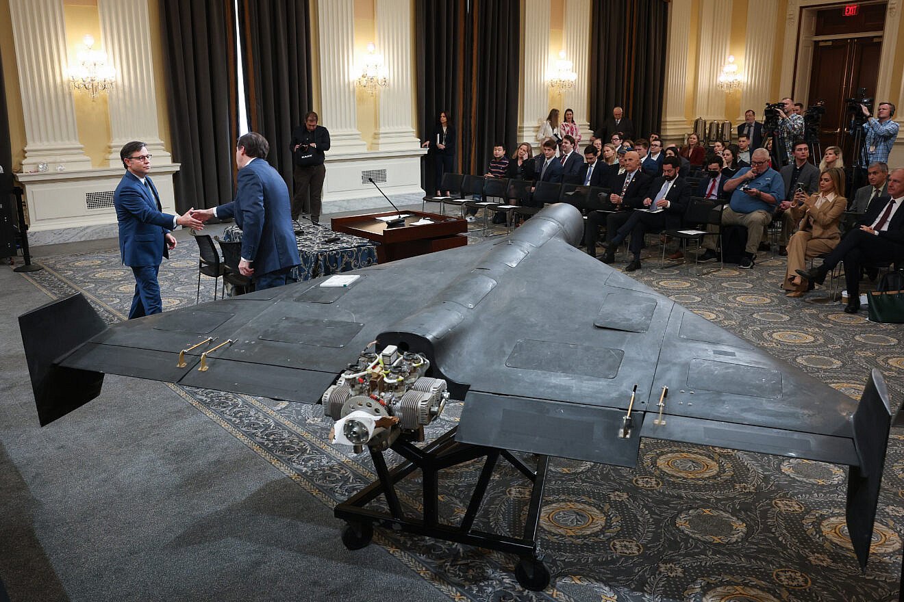 House Speaker Mike Johnson (R-La.) is greeted by Mark Wallace, CEO of the non-profit United Against Nuclear Iran, before Johnson delivered remarks next to a Shahed 136 military drone during a press conference on Capitol Hill, May 8, 2025 . Credit: Win McNamee/Getty Images.