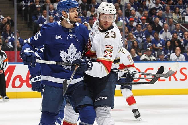Carter Verhaeghe (#23) of the Florida Panthers battles Oliver Ekman-Larsson of the Toronto Maple Leafs during the first period in Game Five of the second round of the Stanley Cup Playoffs at Scotiabank Arena  in Toronto on May 14, 2025. Photo by Claus Andersen/Getty Images.