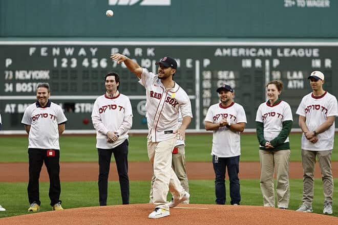 Omer Shem Tov, an Israeli held captive for more than 500 days by Hamas in Gaza, throws out the ceremonial first pitch before a game between the Boston Red Sox and the New York Mets at Fenway Park on May 19, 2025 in Boston, Massachusetts. Photo By Winslow Townson/Getty Images.