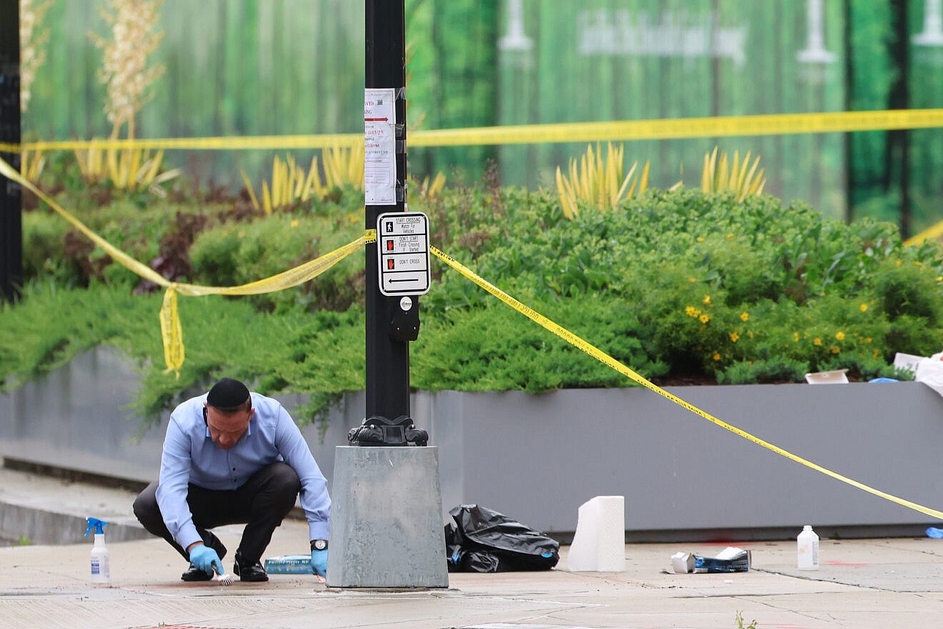 An Orthodox volunteer collects blood and other bodily remains off the sidewalk at the shooting location outside of the Capital Jewish Museum on May 22, 2025. Credit: Tasos Katopodis/Getty Images.