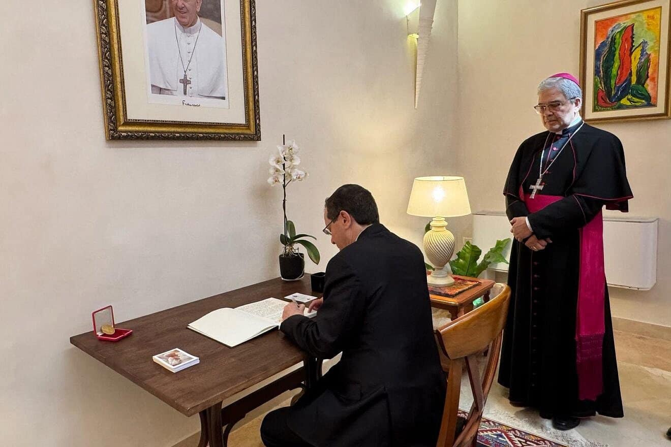 Israeli President Isaac Herzog signs the book of condolences at the Vatican's embassy in Tel Aviv as Apostolic Nuncio Adolfo Tito Camacho Yllana watches, May 2, 2025. Credit: President's Spokesperson.