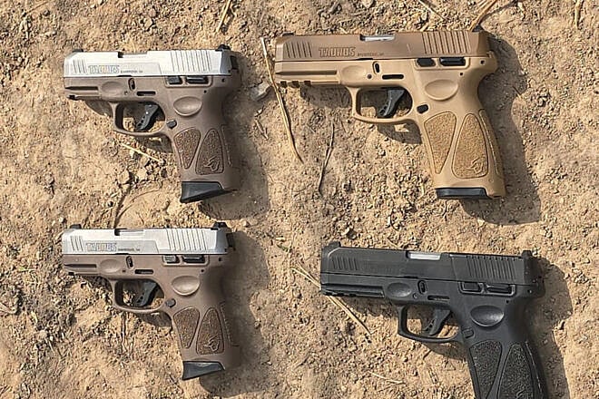 Four handguns seized by Israeli security forces during an attempted smuggling from Jordan on May 5, 2025. Credit: IDF Spokesperson’s Unit.