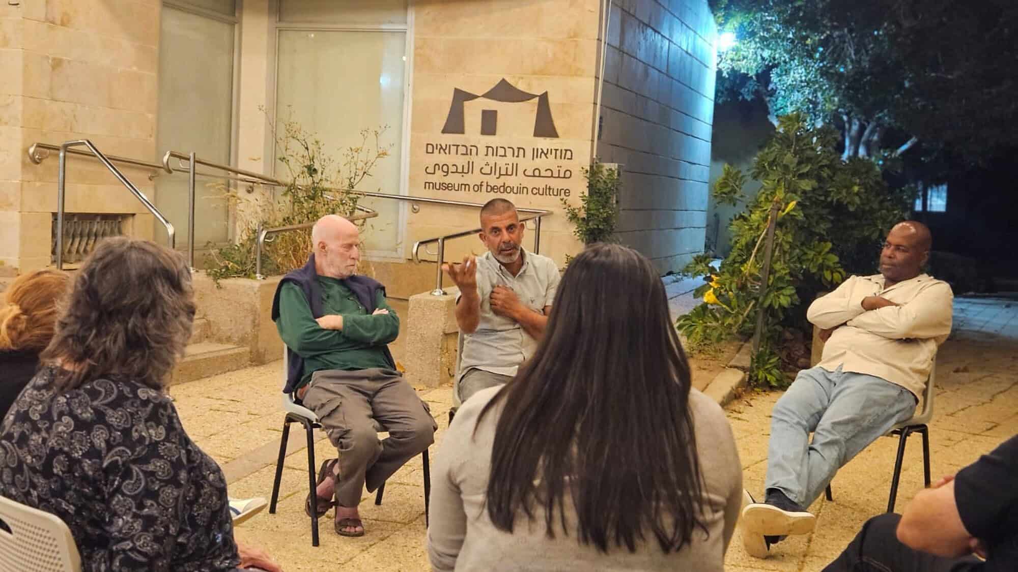 Hamid Abu Ar'ar (center) and Wahid Al-Huzail (right) speak to the audience at the Joe Alon Center near Kibbutz Lahav. Credit: SPIHS.