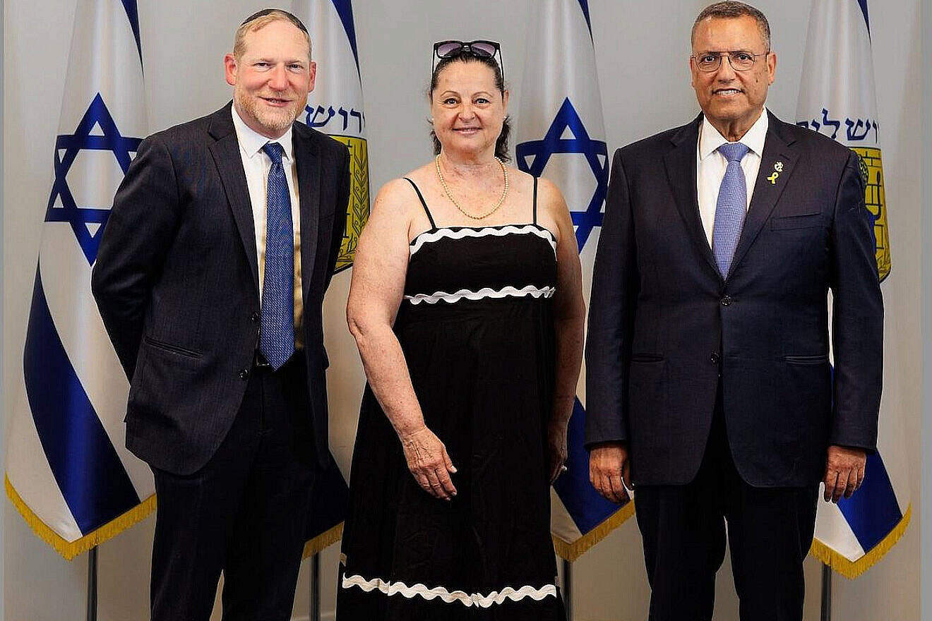 Haddass Engel is welcomed to her new home in Israel by Rabbi Yehoshua Fass, co-founder and executive director of Nefesh B’Nefesh (left), and Jerusalem Mayor Moshe Lion. Photo by Asher Stein.