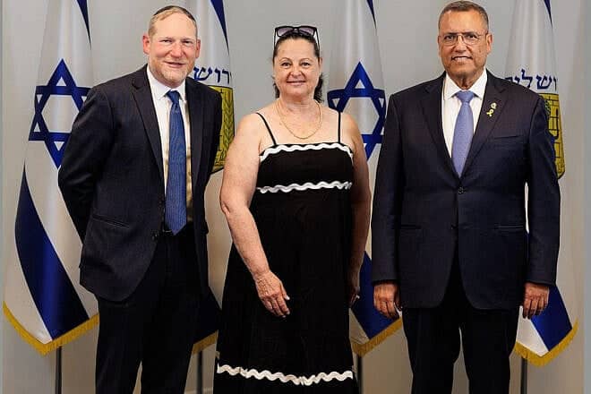 Haddass Engel is welcomed to her new home in Israel by Rabbi Yehoshua Fass, co-founder and executive director of Nefesh B’Nefesh (left), and Jerusalem Mayor Moshe Lion. Photo by Asher Stein.