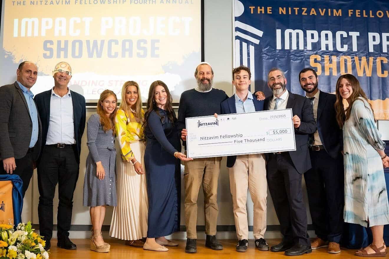 Gap-year students celebrate the culmination of their program in Israel at a ceremony held at Hebrew University’s Rothberg International School in Jerusalem. As part of the proceedings, Ben Goodman of New York holds a check for $5,000 for his winning project, Chaverut, May 27, 2025. Credit: Chaim H Photography.