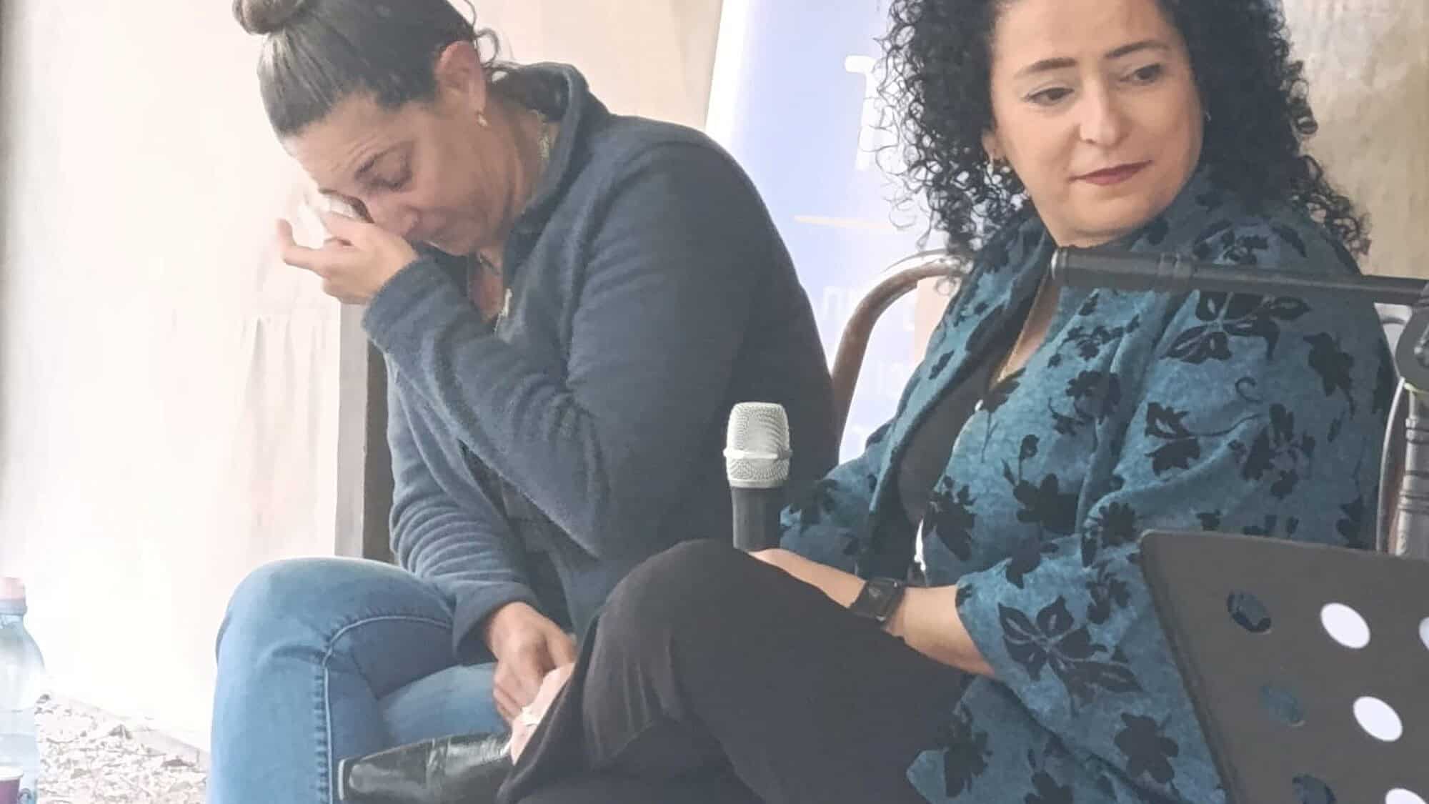Moran Moses (left) tears up as she shares her story with interviewer Racheli Avidov at the Valley Train Site in Kfar Yehoshua. Credit: Society for Preservation of Israel Heritage Sites.