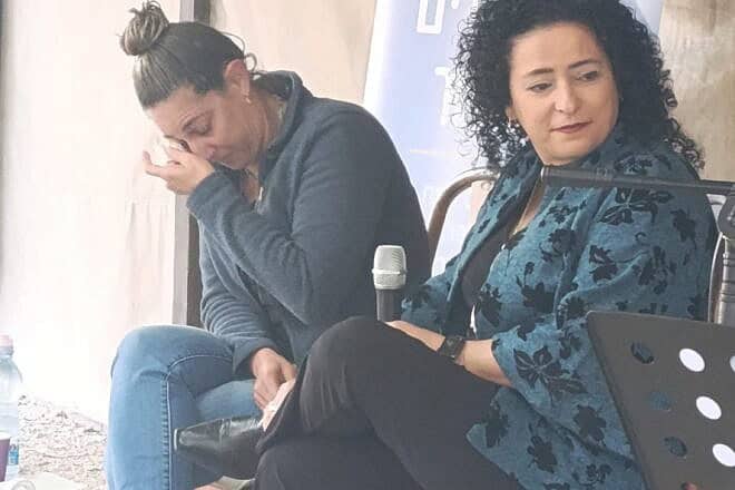 Moran Moses (left) tears up as she shares her story with interviewer Racheli Avidov at the Valley Train Site in Kfar Yehoshua. Credit: Society for Preservation of Israel Heritage Sites.