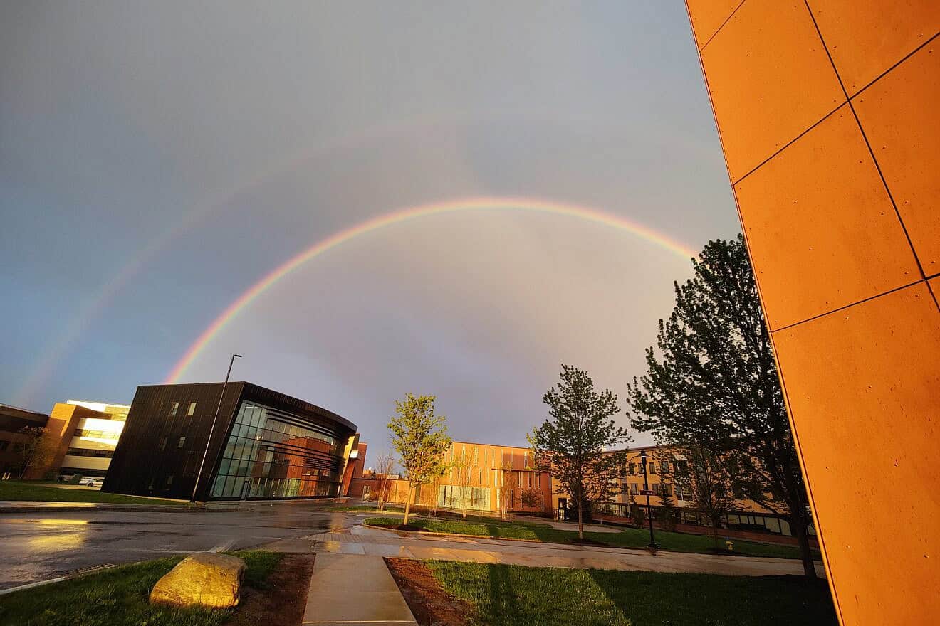 A rainbow seen over Cybersecurity Hall at Rochester Institute of Technology in New York, May 1, 2023. Credit: Catsup31 via Wikimedia Commons.
