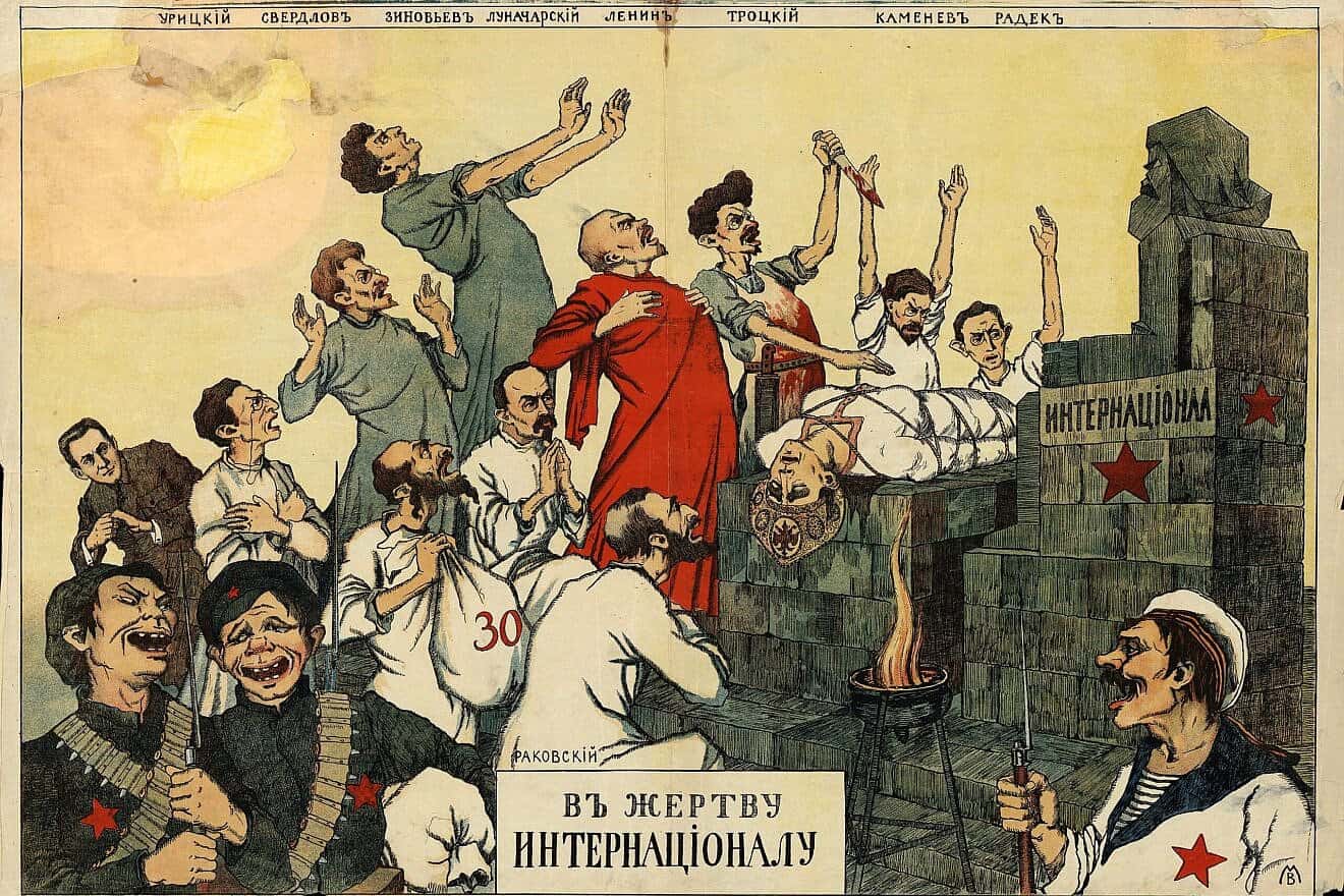 “Sacrifice to the International, a White Russian, anti-Bolshevik propaganda poster produced during the Russian Civil War. In this image, a number of senior Bolsheviks—Moisei Uritzky, Yakov Sverdlov, Grigory Zinoviev, Anatoly Lunacharsky, Vladmir Lenin, Grigory Petrovsky, Leon Trotsky, Lev Kamenev and Karl Radek—sacrifice an allegorical character representing Russia to a statue of Karl Marx, 1918-1919. Credit: Public Domain in Russia via Wikimedia Commons.