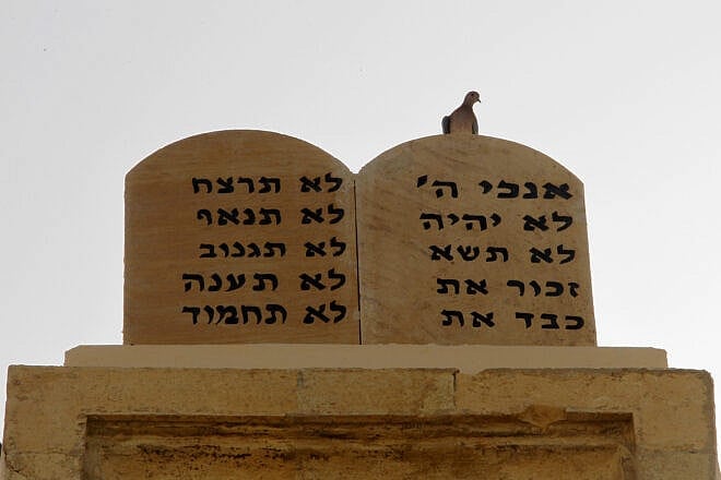 A pigeon perches on stone tablets bearing the Ten Commandments in Hebrew on top of the Magen Abraham Synagogue in downtown Beirut on Oct. 19, 2010. A few hundred Jews live in Lebanon, compared to 24,000 in 1948. Photo credit should read JOSEPH EID/AFP via Getty Images.