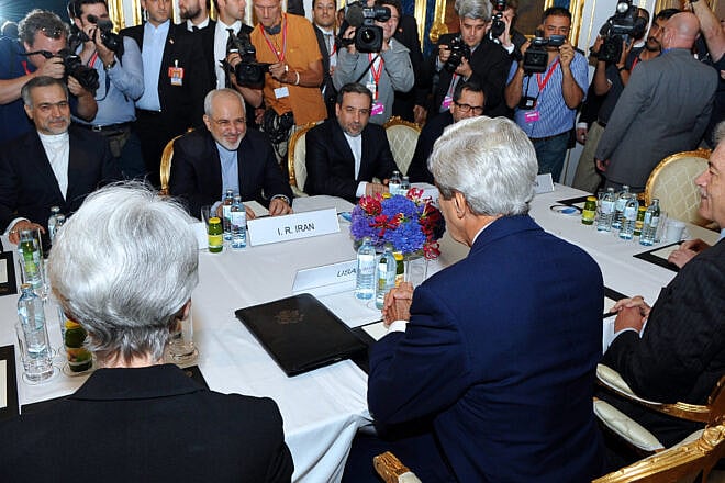 U.S. Secretary of State John Kerry sits across from Iranian Foreign Minister Mohammad Javad Zarif in Vienna, Austria, before they begin a bilateral meeting focused on Iran's nuclear program and a year before a deal is signed, July 13, 2014. Credit: U.S. State Department Photo/ Public Domain via Wikimedia Commons.
