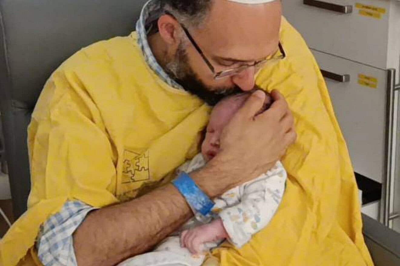 Hananel Gez cradles his mortally wounded infant son, Ravid Chaim Gez, in his arms at Schneider Children's Medical Center in Petach Tikvah, Israel. Credit: Courtesy of the Gez family.