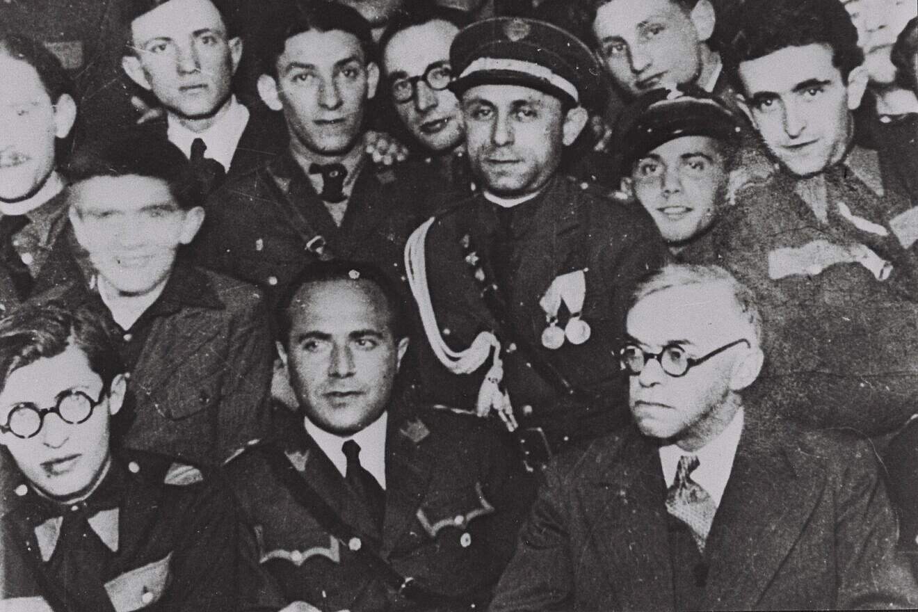 Ze’ev Jabotinsky (bottom right) at a meeting with Betar leaders in Warsaw, including (bottom, left) Menachem Begin, circa 1939. Credit: National Photo Collection of Israel/Photography Department, Government Press Office via Wikimedia Commons.