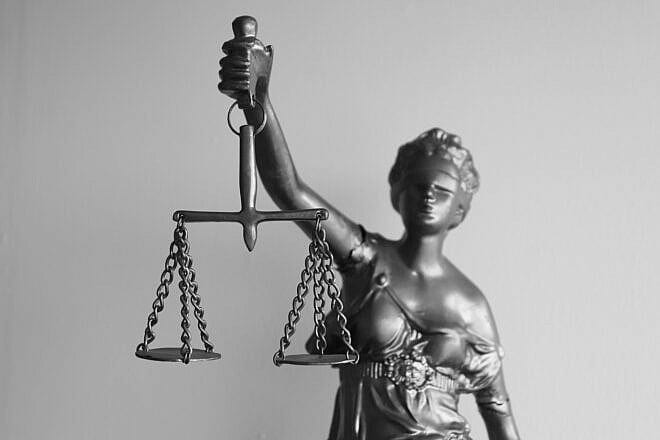 Statue of Lady Justice on a gray background. Credit: Ezequiel Octaviano/Pixabay.