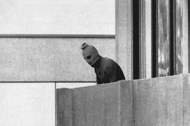A terrorist appears with a hood over his face on the balcony of the building where members of the Olympics Israeli team were held hostage in Munich, Sept. 5, 1972. Photo credit: AP Photo/Russell McPhedran/Wikimedia Commons