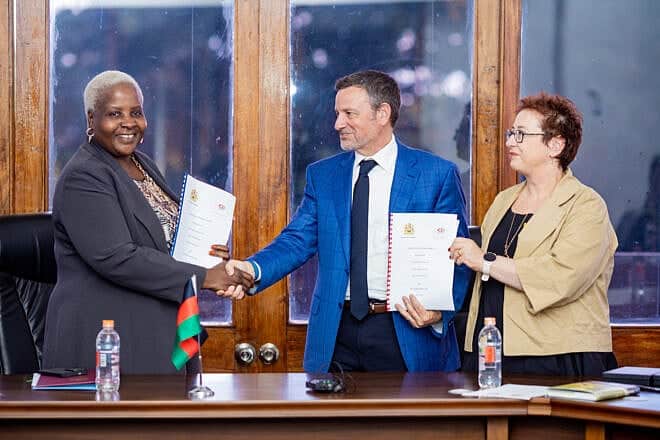 From left, Khumbize Kandodo Chiponda, the minister of health of Malawi, is joined by Jay Ruderman, president of the Ruderman Family Foundation, and Avital Sandler-Loeff, executive director of the American Jewish Joint Distribution Committee's disaster relief and international development unit, at the signing of an agreement to kick off ImpactWell's work in the African country. Credit: Courtesy of Dynamic Resolution.