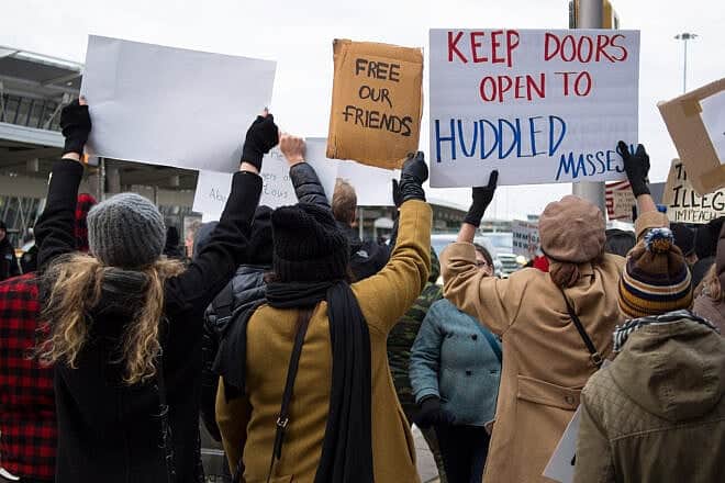Demonstrators outside John F. Kennedy International Airport in New York City to protest President Donald Trump's travel ban during his first term in office, on Jan. 28, 2017. Credit: Rhododendrites via Wikimedia Commons.