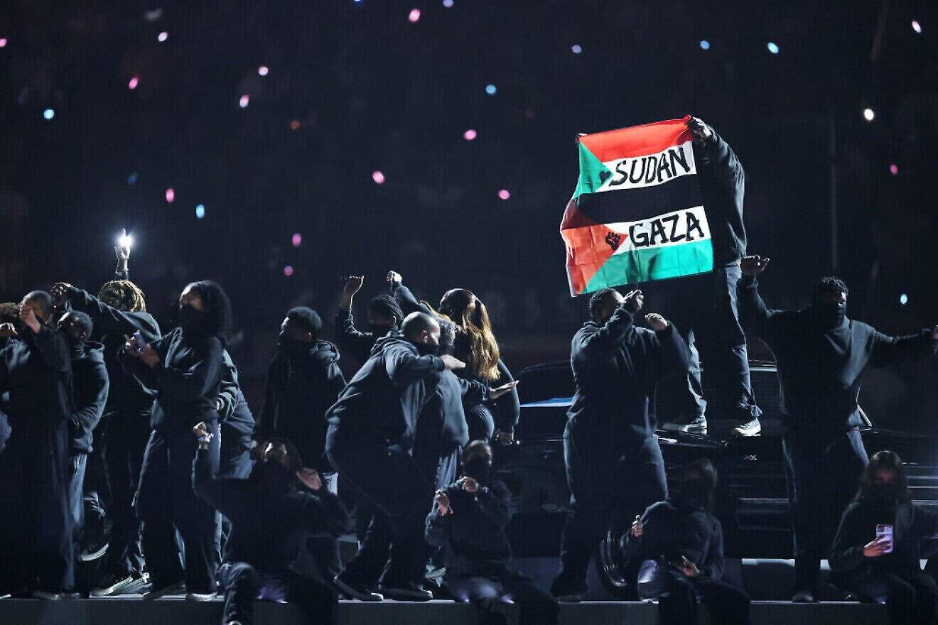 A protester holds a combined Sudan/PLO flag during the half-time show at Super Bowl LIX at Caesars Superdome in New Orleans, La., on Feb. 09, 2025. Photo by Emilee Chinn/Getty Images.